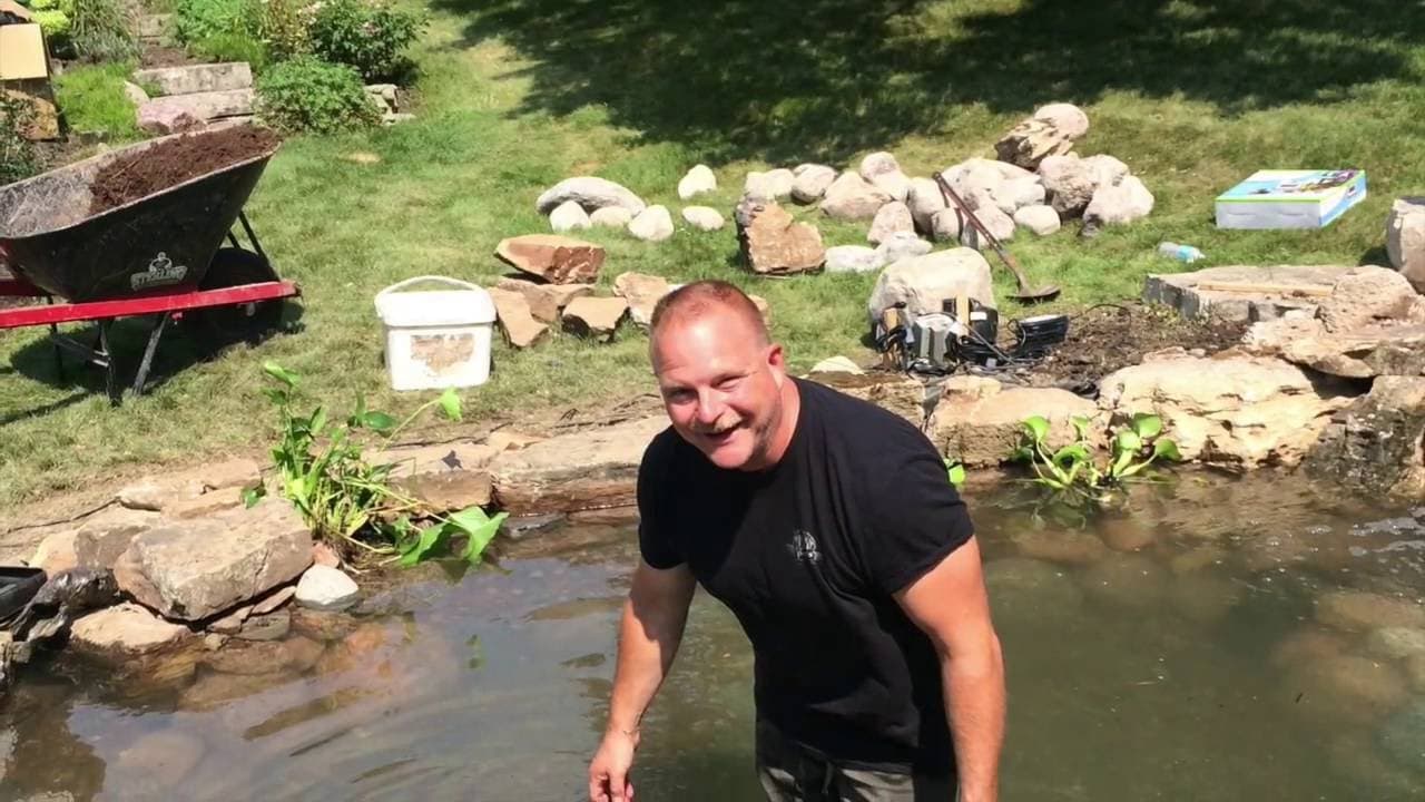 Man working on pond